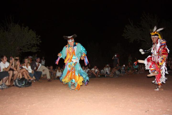 a group of people performing on stage in front of a crowd