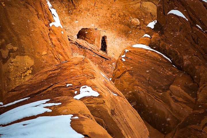 a view of a snow covered ruin in monument valley