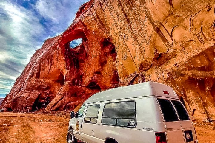 a close up of an enclosed van in backcountry near suns eye